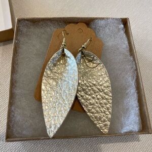 Leather, wire earrings. Gold foil finish. Never worn, I can’t wear wires.